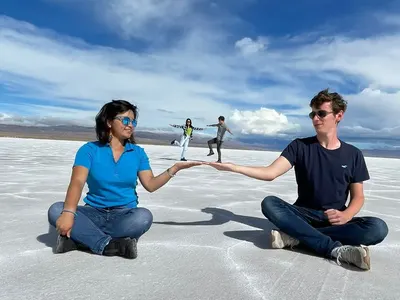Two friends posing on a white salt flat in Argentina