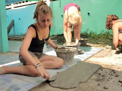 Placing new floor tiles, construction project in Costa Rica
