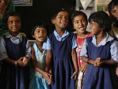 Smiling schoolgirls in blue uniforms in India