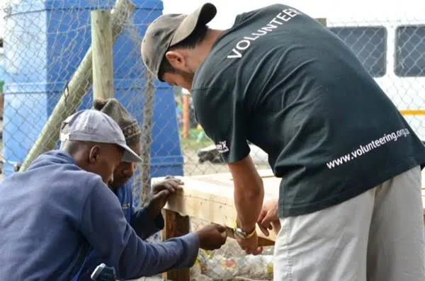 Volunteer working alongside local craftsmen in a workshop in South Africa